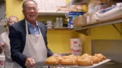Ted carrying a tray of douhgnuts