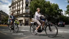 Woman rides her bike through Paris