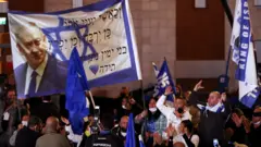 Supporters of Israeli Prime Minister Benjamin Netanyahu's Likud party react following the release of exit polls for the general election on 23 March 2021