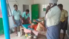 வெங்கடாசலம் தந்தையை கட்டிலோடு தூக்கும் அதிகாரிகள்.