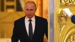 Russian President Vladimir Putin enters the hall during the reception marking the Day of Heroes of the Fatherland at Grand Kremlin Palace in Moscow, 11 December 2019