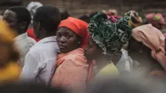 Residents gather for a distribution of utensils organised by the Catholic relief organisation Caritas in the village of Muagamula, outside Macomia, northern Mozambique on August 24, 2019. Pope Francis is scheduled to visit Mozambique, Madagascar and Mauritius in a pastoral visit from September 4th to September 10th.