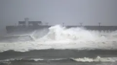 Waves break ashore near rthe Gulf State Park pier as the outer bands of Hurricane Sally come ashore on September 15, 2020 in Gulf Shores, Alabama