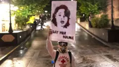 Protester holds picture of Breonna Taylor