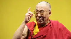 Tibetan spiritual leader his Holiness The Dalai Lama gestures on his arrival at JAKO Arena on May 18, 2008 in Bamberg, Germany.