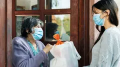 a women giving a charity to another women