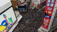 An aerial shot shows thousands of protesters filling a street for a rally on New Year's Day in Hong Kong