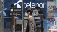 Man walks past Telenor showroom in Yangon, Myanmar, on 4 February 2021