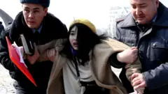 Kyrgyz police arrest a woman activist on Victory Square during the celebration of International Women's Day in Bishkek, Kyrgyzstan, 8 March 2020