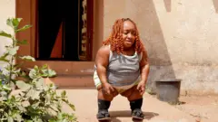 A woman stands in front of a door