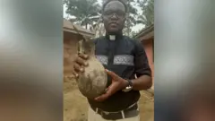  Echezona Obiagbaosogu carrying a gourd