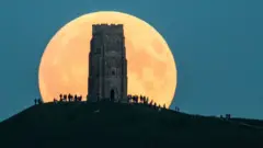 The supermoon rises behind Glastonbury Tor on September 27, 2015 in Glastonbury, England.
