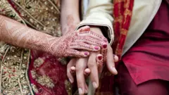 A couple hold hands on their wedding day
