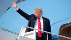 Donald Trump waves as he boars Air Force One prior to departing from Joint Base Andrews in Maryland, July 3, 2020