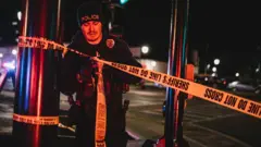 A police officer cordons off a crime scene on November 21, 2021 in Waukesha, Wisconsin.