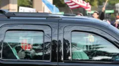 President Trump is driven past supporters outside Walter Reed Medical Center, 4 October 2020