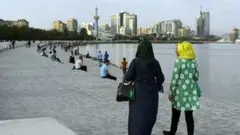 Two women in headscarves take a walk along Baku's seafront