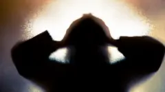 A person holds their head in a treated image