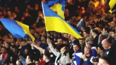 Scotland fans wave Ukraine flags at their friendly against Poland in March