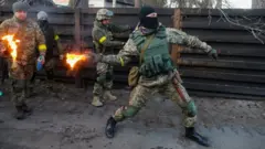 A member of the Ukrainian Territorial Defence Forces trains to throw Molotov cocktails in Kyiv