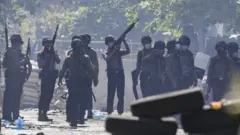 Police officers search for hiding demonstrators
