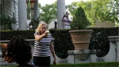 Patricia McCloskey and her husband Mark McCloskey draw their firearms on protesters in St Louis, Missouri, on 28 June 2020.