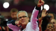 John Geddert celebrates with the US Olympic gymnast team at the London Games in 2012