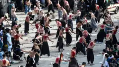 Shiite Muslims flagellate themselves for an Ashura procession during the month of Muharram in Quetta on August 30, 2020. - Ashura is a period of mourning for Shiite Muslims during Muharram commemorations to mark the seven-century martyrdom of Prophet Mohammad's grandson Imam Hussein who was killed in battle in Karbala in Iraq 680 AD.
