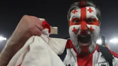 Georgia fan celebrates his team reaching Euro 2024