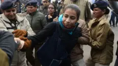Police detain a woman at a demonstration against Indias new citizenship law in New Delhi on December 19, 2019.