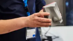 A man holding an ATT e-nose