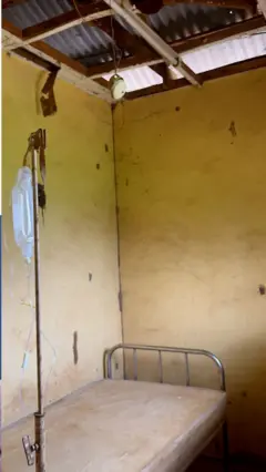 A single bed with drip and dilapidated worn out roof