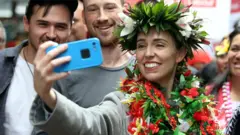New Zealand"s Prime Minister Jacinda Ardern takes pictures with supporters during a campaign outing at Mangere Town Centre and market in Auckland, New Zealand, October 10, 2020.