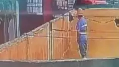Screengrab of the clip shows a working standing in the container