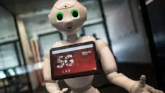 Pepper robot with screen advertising 5G logo