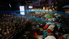 People are hit with water from water cannons during an anti-government protest, in Bangkok, Thailand October 16, 2020.