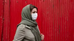 An Iranian woman wearing a protective face mask