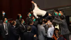 Pro-democracy lawmaker Ted Hui tried to jump onto the chairman's bench