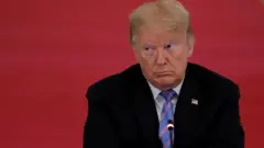 U.S. President Donald Trump listens during a meeting of the American Workforce Policy Advisory Board in the East Room at the White House in Washington