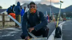 A construction worker in the informal sector who has lost his job in South Africa