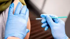 Marie Rohlfs, teacher at the Sternschnuppe Kindergarten receives a dose of AstraZeneca"s vaccine against the coronavirus disease (COVID-19) from Thomas Holler in Bremen, Germany, February 26, 2021.