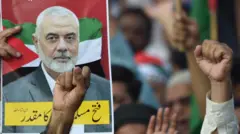 Poster of Hamas's political leader Haniyeh being held above crowds