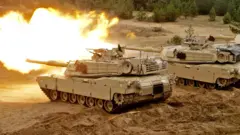 A US Army Abrams tank fires during the Saber Strike military exercises in Adazi military training area, Latvia, 11 June 2016