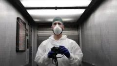 A member of hospital staff with a camera