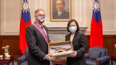 Taiwan"s President Tsai Ing-wen poses for pictures with Former U.S. Secretary of State Mike Pompeo after he was bestowed with an Order of Brilliant Star with Grand Cordon at the presidential building in Taipei, Taiwan, March 3, 2022.