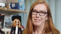 Undated handout photo issued by Mattel of Professor Dame Sarah Gilbert holding a Barbie doll of herself in honour of the Oxford vaccine co-creator.