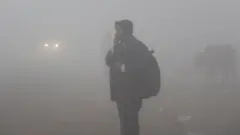 Students are seen wearing warm clothes to school amid dense fog on a cold winter morning, on December 30, 2019 in Gurugram, India.