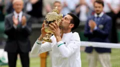 novak djokovic with wimbledon trophy