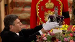 Crown being taken from the coffin