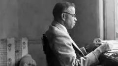 वीपी मेनन अपनी मेज पर बैठकर काम करते हुए